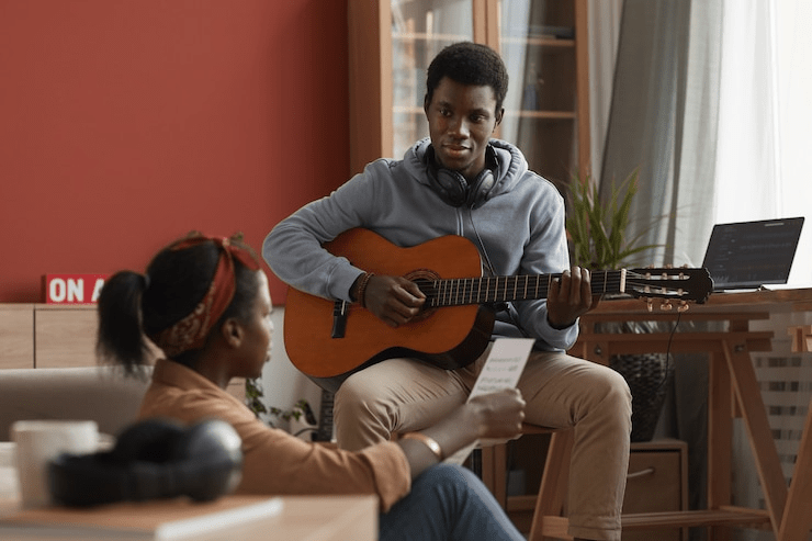 imgi_1_portrait-two-young-african-american-musicians-playing-guitar-writing-music-